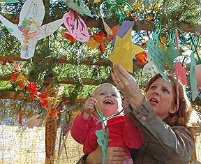 PHOTO: mom and child in the sukkah