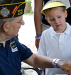 PHOTO: veteran planting with child