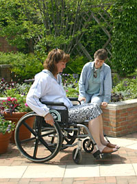 PHOTO: woman in wheelchair working in a raised bed garden