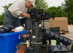 PHOTO: Garden employee sorting plant containers for recycling