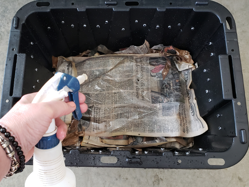 Composting: spritz newspaper with water
