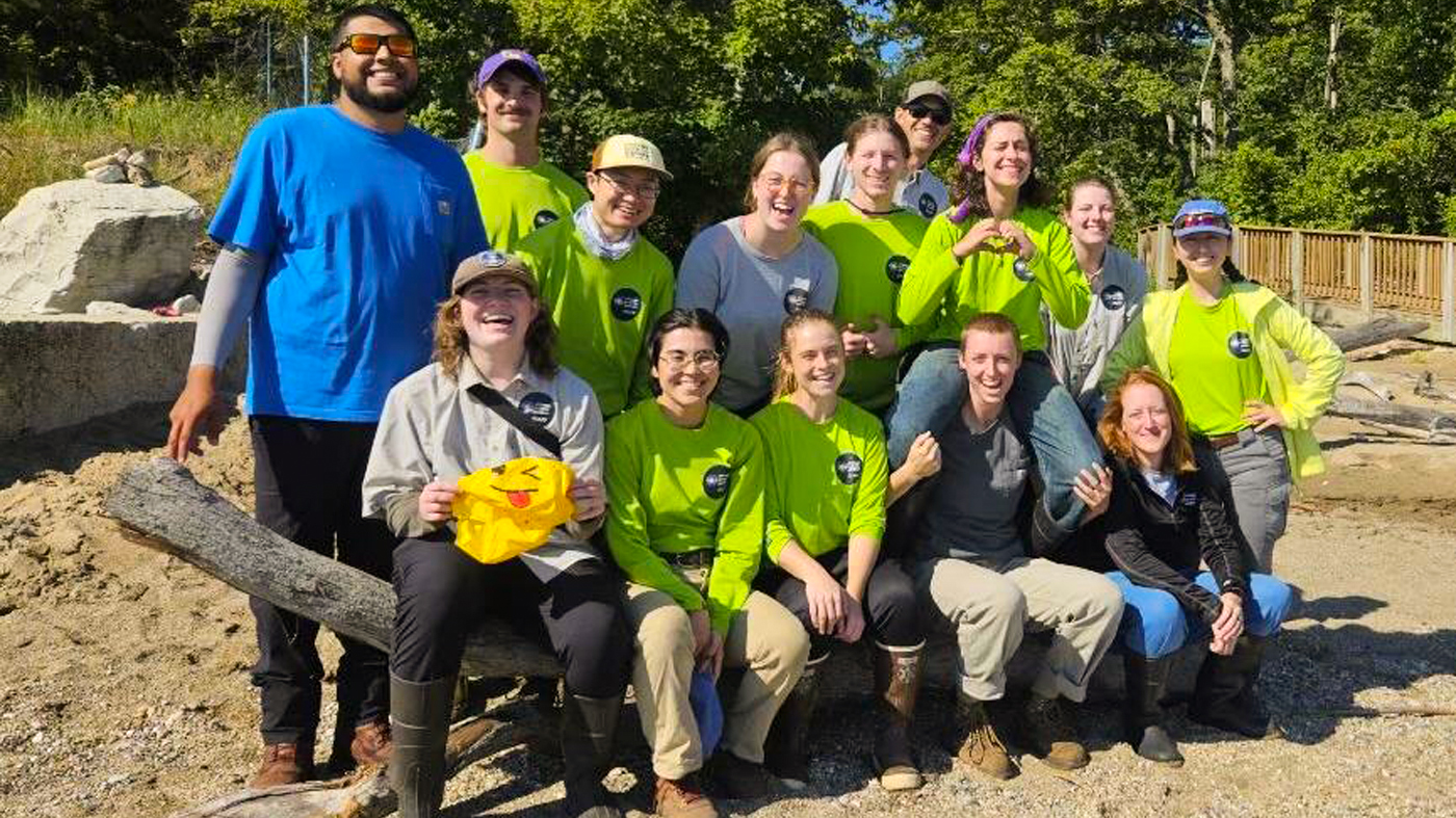 A group of SENA technicians pose for a photo in a natural area.