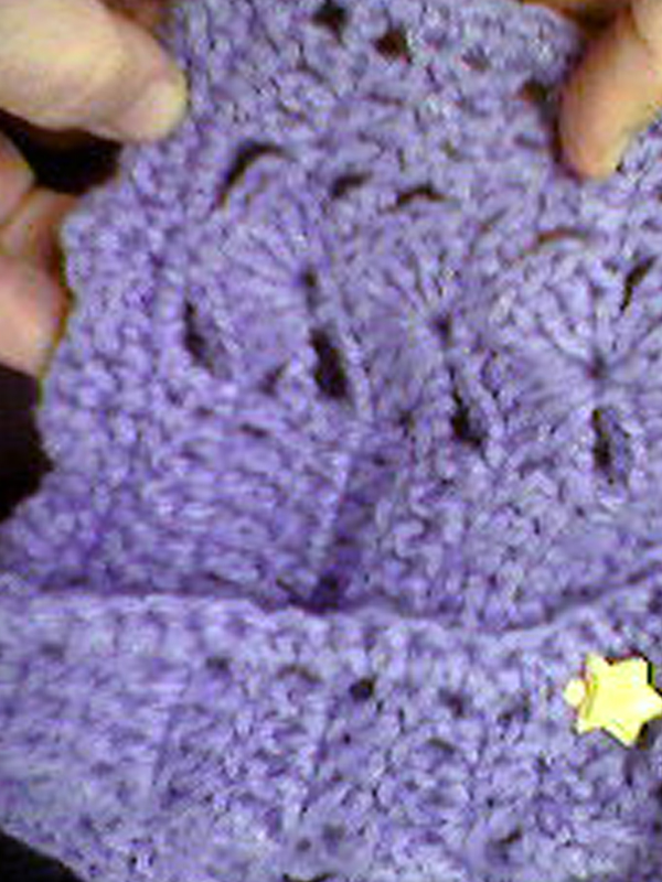 A stickpin holds this beautiful crochet work in place.