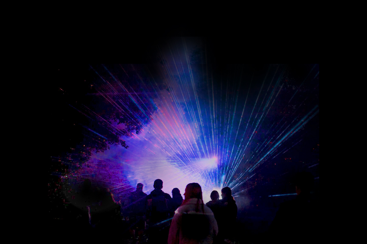 Family walking through Lightscape illuminated by glowing fire-themed installations at night