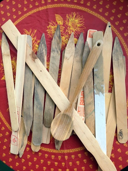 BEFORE: Clean out the paint shelf! Old paint stirrers, stakes, and even wooden spoons can work as plant markers.