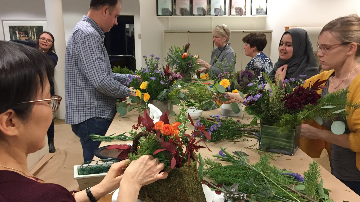 Communication Department gathering making floral arrangements