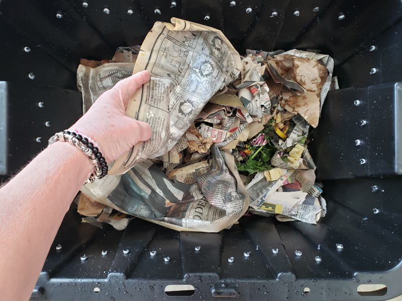 Composting: add food, peel back the top paper