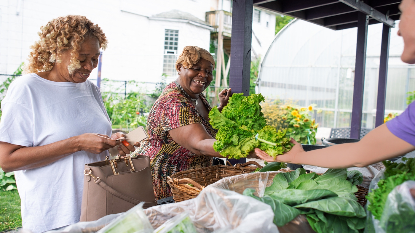 Women buying produce at farm stand